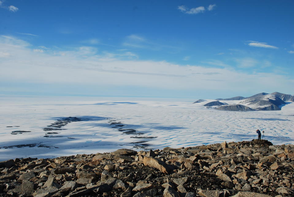 Luke Copland, University Research Chair in Glaciology, Department of Geography, University of Ottawa, overlooks the Milne Ice Shelf. Adrienne White, PhD, who took the photo, said the majority of the ice seen on the left side of the image is now gone. / Credit: Adrienne White, PhD