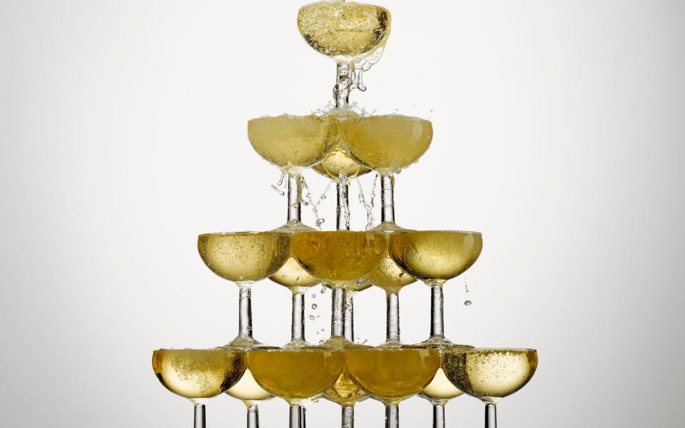 Champagne pouring into stacked glasses - Andy Roberts/ OJO Images RF
