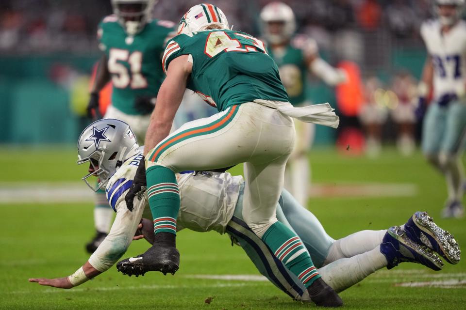 Miami Dolphins linebacker Andrew Van Ginkel (43) slings down Dallas Cowboys quarterback Dak Prescott (4) during the first half of an NFL game at Hard Rock Stadium in Miami Gardens, Dec. 24, 2023.