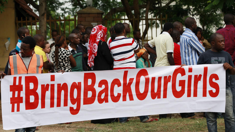People attend a rally calling on the Government to rescue the school girls kidnapped from the Chibok Government secondary school, in Abuja, Nigeria, Saturday May 10, 2014. The president of Nigeria for weeks refused international help to search for more than 300 girls abducted from a school by Islamic extremists, one in a series of missteps that have led to growing international outrage against the government. The waiting has left parents in agony, especially since they fear some of their daughters have been forced into marriage with their abductors for a nominal bride price of $12. Boko Haram leader Abubakar Shekau called the girls slaves in a video this week and vowed to sell them. "For a good 11 days, our daughters were sitting in one place," said Enoch Mark, the anguished father of two girls abducted from the Chibok Government Girls Secondary School. "They camped them near Chibok, not more than 30 kilometers, and no help in hand. For a good 11 days." (AP Photo/Sunday Alamba)
