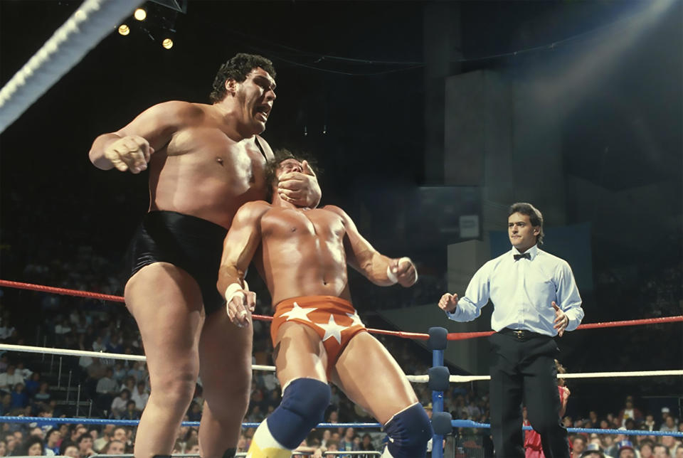 Andre the Giant manhandles "Macho Man" Randy Savage during a wrestling match