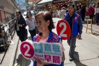 People campaign for Jacqueline Chung, a candidate in Sunday's district council elections in Hong Kong