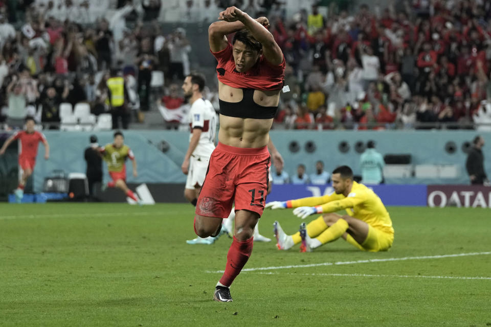 South Korea's Hwang Hee-chan celebrates after scoring his side's 2nd goal during the World Cup group H soccer match between South Korea and Portugal, at the Education City Stadium in Al Rayyan , Qatar, Friday, Dec. 2, 2022. (AP Photo/Hassan Ammar)