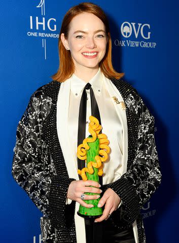 <p>Presley Ann/Getty Images</p> Emma Stone, winner of the Desert Palm Achievement Award for "Poor Things," poses backstage during the 35th Annual Palm Springs International Film Awards