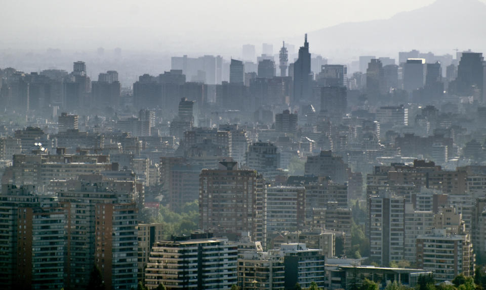 Santiago de Chile city skyline dense urban growth and landmark tower in the haze