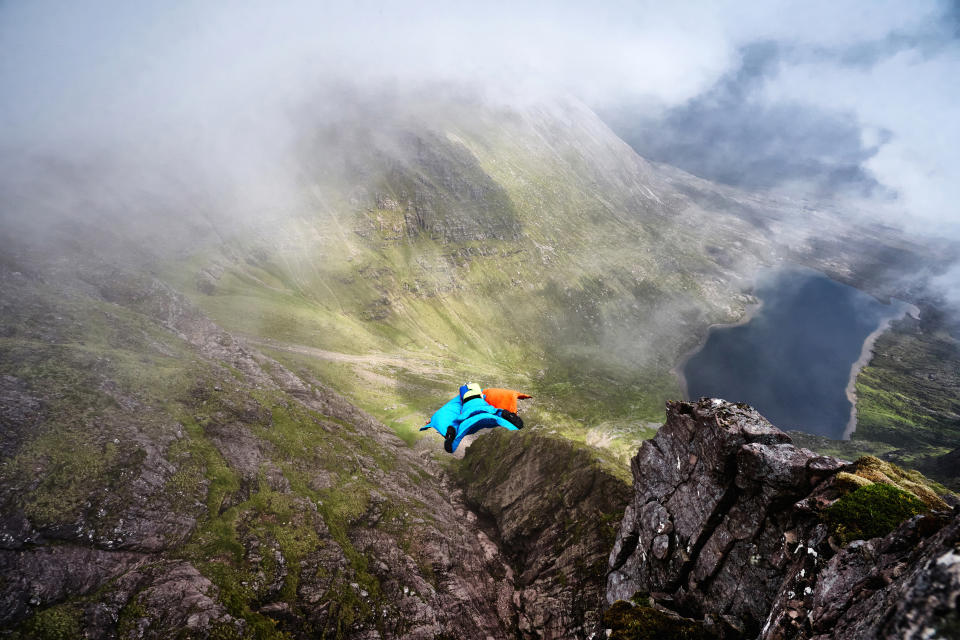 A brave base jumper has become the first person ever to fly a wingsuit from the top of a British mountain. Former Royal Marine Tim Howell, 31, leapt from the 4,000ft peak of An Teallach in the northwest Highlands in Scotland. He plunged down a steep gully for 30 seconds before deploying his parachute and landing safely on the banks of Loch Toll an Lochain.