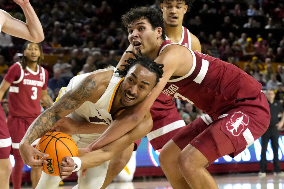 Stanford Cardinal forward Brandon Angel, right, ties up Arizona State guard Frankie Collins, left, during the second half of an NCAA college basketball game Thursday, Feb. 1, 2024, in Tempe, Ariz. Stanford won 71-62. (AP Photo/Ross D. Franklin)