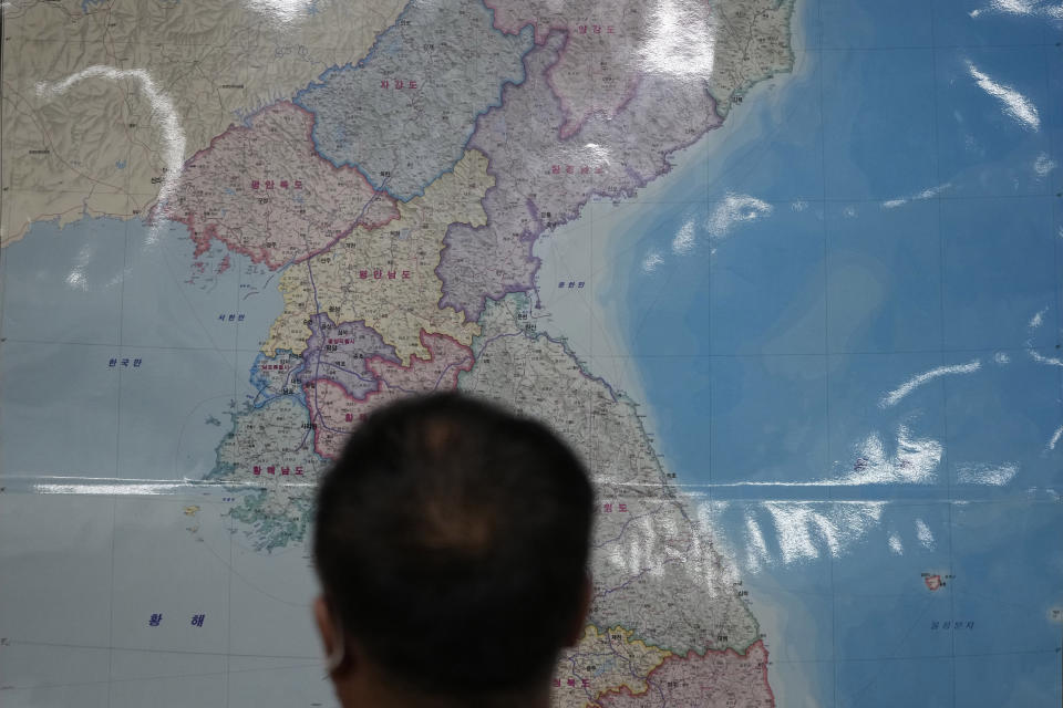 A Chinese-North Korean refugee who wished to be identified only as Yoon speaks in front of map of Korean peninsula during an interview in Seoul, South Korea, Monday, Sept. 13, 2021. Thousands of ethnic Chinese have lived in North Korea for generations. Though many maintain Chinese nationality, they still consider themselves North Koreans because they go to the same schools and work at the same factories with North Koreans. (AP Photo/Lee Jin-man)