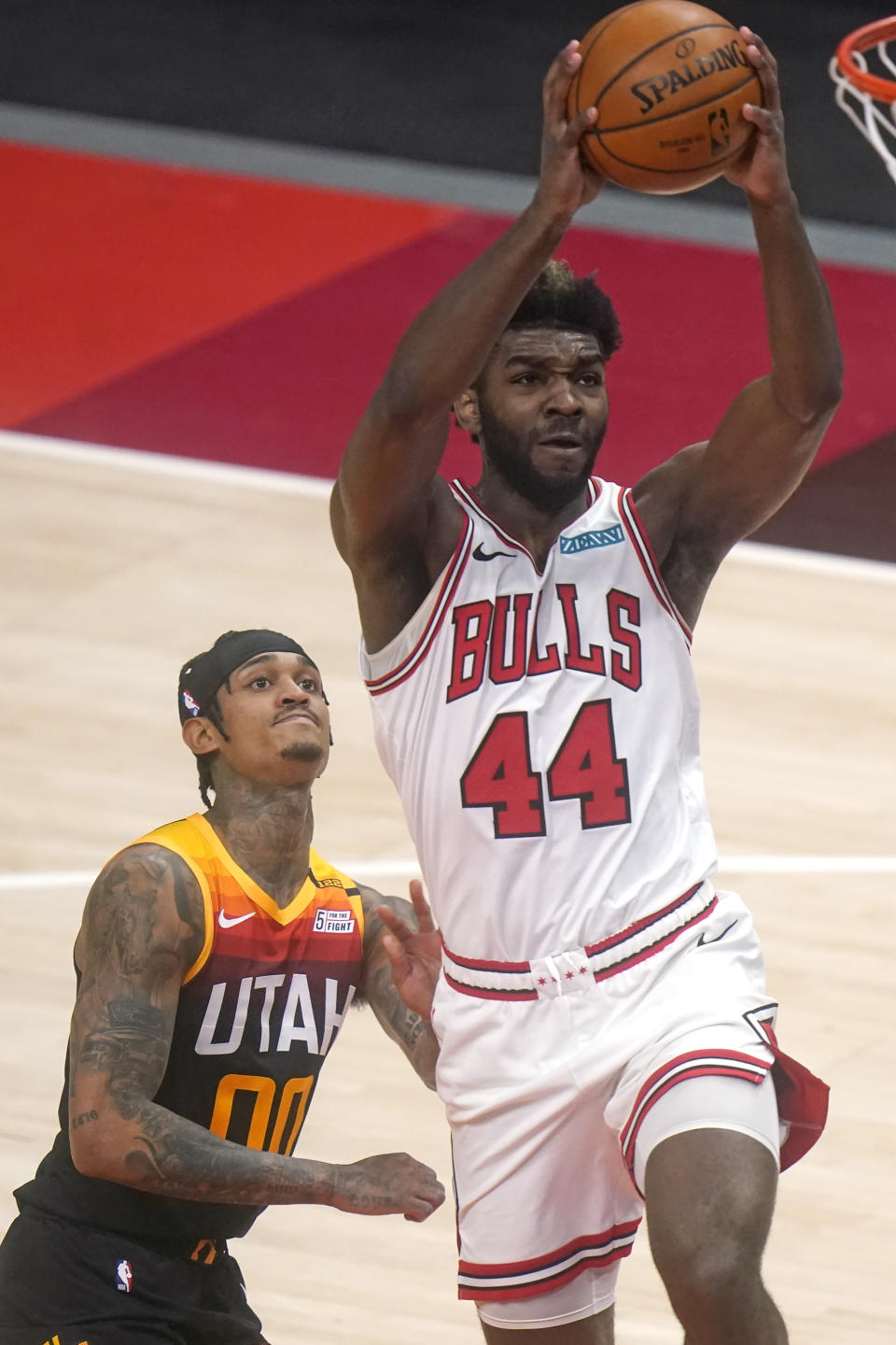 Chicago Bulls forward Patrick Williams (44) goes to the basket as Utah Jazz guard Jordan Clarkson (00) looks on in the first half during an NBA basketball game Friday, April 2, 2021, in Salt Lake City. (AP Photo/Rick Bowmer)