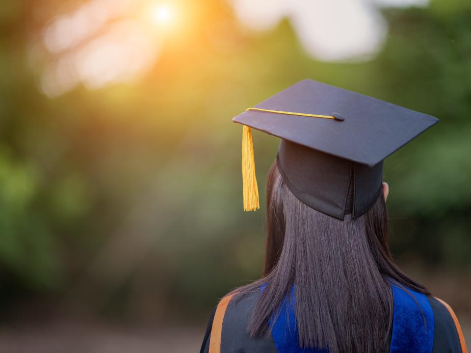 Rear view of college graduate