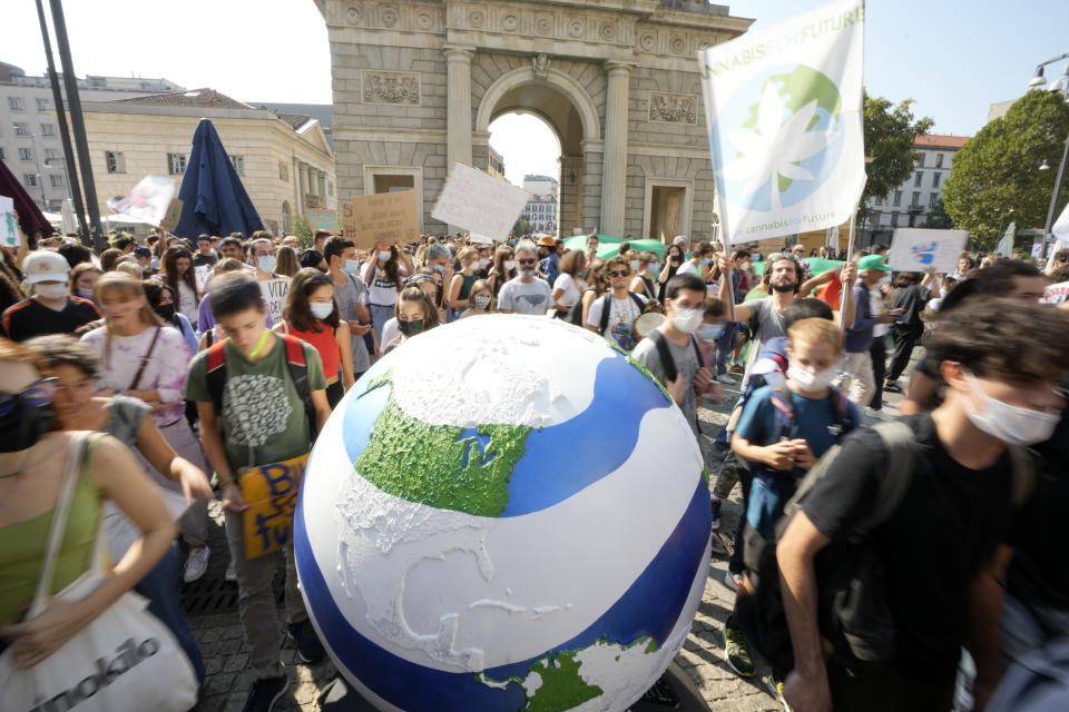 Students march as part of the Fridays for Future climate movement's initiatives, in Milan, Italy, Friday, Sept. 24, 2021. Environmental activists, many of them students taking time out from school, are staging rallies around the world to demand that leaders take stronger action to curb climate change. (AP Photo/Luca Bruno)