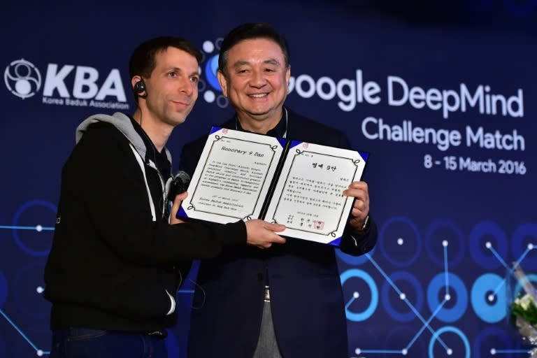 Google's AlphaGo was awarded the highest Go rank of "ninth dan" -- reserved for those whose ability at the ancient board game borders on "divinity" -- by Hong Seok-Hyun (right) at a ceremony in Seoul, on March 16, 2016