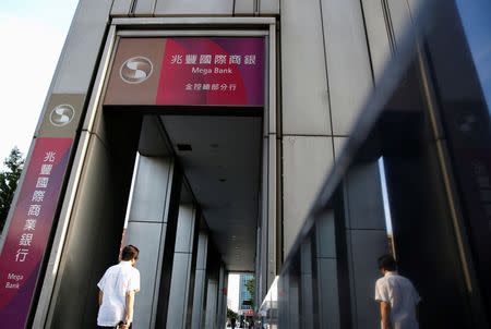 A man walks past a bureau of Mega International Commercial Bank in Taipei, Taiwan August 23, 2016. REUTERS/Tyrone Siu