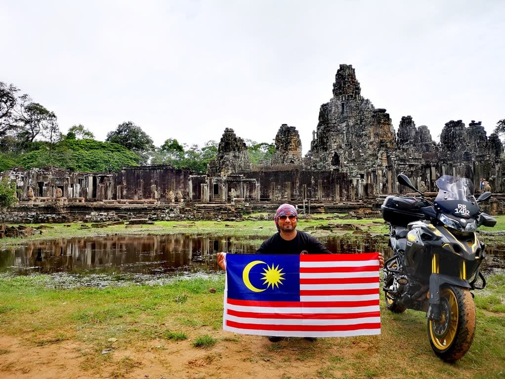 Harprit Singh aka Rider Chris poses at Bayon Temple in Angkor, Cambodia with the Jalur Gemilang. – Pictures courtesy of Rider Chris