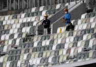 Workers are seen at the construction site of the New National Stadium, the main stadium of Tokyo 2020 Olympics and Paralympics, during a media opportunity in Tokyo, Japan