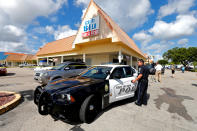 <p>A Fort Myers police officer is seen at a parking lot of Club Blu after a shooting in Fort Myers, Fla., July 25, 2016. (REUTERS/Joe Skipper)</p>