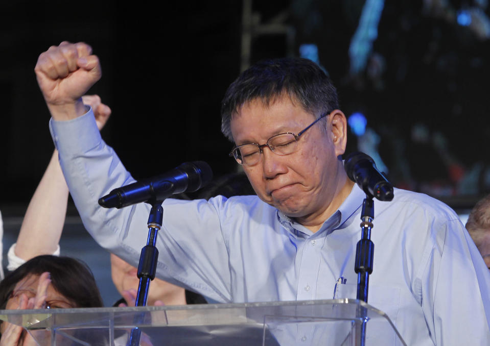 Taipei city mayor and city mayoral candidate Ko Wen-je celebrates his victory with supporters in Taipei, Taiwan, Sunday early morning, Nov. 25, 2018. Taiwan's ruling party suffered a major defeat Saturday in local elections seen as a referendum on the administration of the island's independence-leaning president amid growing economic and political pressure from China. (AP Photo/Chiang Ying-ying)