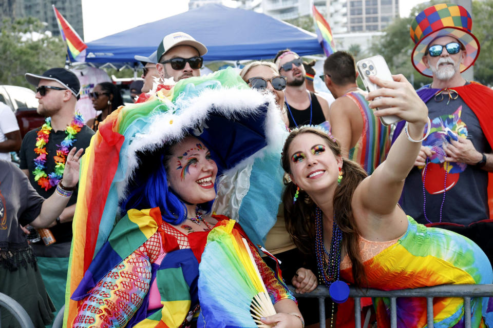 Parade participants interact with people in the crowd during the St. Pete Pride Parade along Bayshore Drive on Saturday, June 24, 2023, in St. Petersburg, Fla. (Jefferee Woo/Tampa Bay Times via AP)