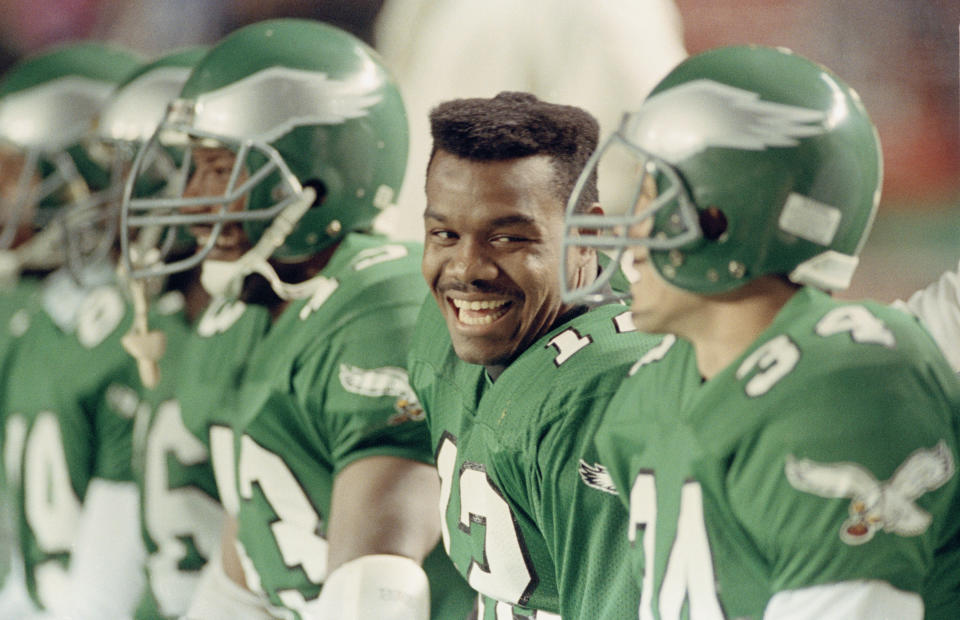 Philadelphia Eagles quarterback Randall Cunningham laughs with teammates on the bench during a 1990 game. (AP Photo/Rusty Kennedy)