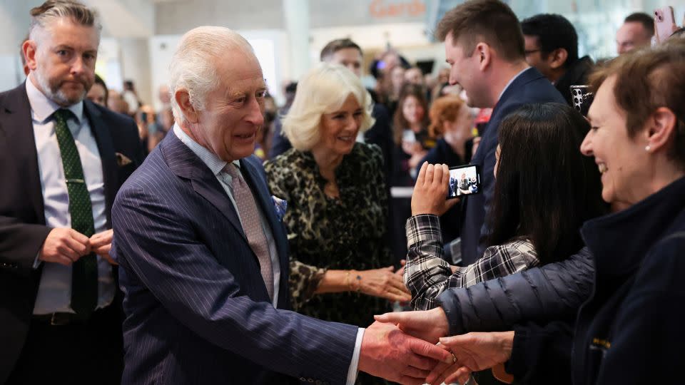 The King and Queen meet staff as they arrive at the cancer treatment center. - Suzanne Plunkett/Reuters