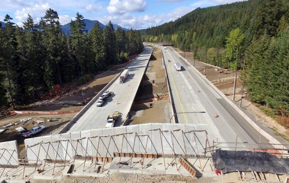 Interstate 90 traffic passes beneath a wildlife bridge under construction on Snoqualmie Pass, Wash., on Oct. 4, 2018. New Mexico will build its first wildlife highway overpasses for free-roaming cougars, black bears, bighorn sheep and other creatures large and small and will also set aside $100 million for conservation projects, under two bills signed Thursday, March 23, 2023. by Gov. Michelle Lujan Grisham.