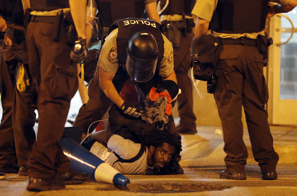 <p>Police arrest a man as demonstrators march in response to a not guilty verdict in the trial of former St. Louis police officer Jason Stockley, Sunday, Sept. 17, 2017, in St. Louis. Stockley was acquitted in the 2011 killing of a black man following a high-speed chase. (Photo: Jeff Roberson/AP) </p>