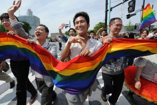 Gay people carry a rainbow flag as they march on the street during the Tokyo Rainbow Pride 2012 in Tokyo. Some 2,500 people marched in the parade in Tokyo on Sunday, vowing to transform a low-profile campaign for the rights of sexual minorities into a major movement in Japan