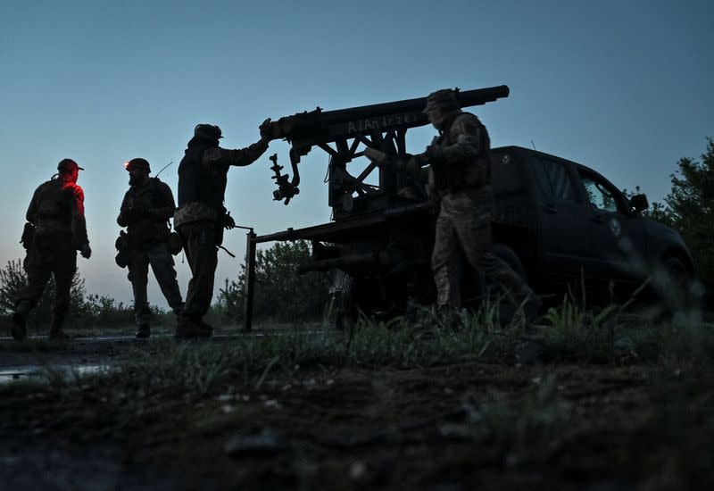 Members of company tactical group "Steppe Wolves" prepare a handmade small MLRS for firing toward Russian troops in Zaporizhzhia region