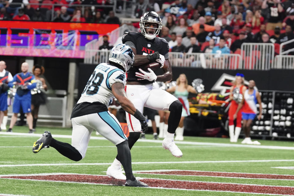 Atlanta Falcons tight end Kyle Pitts catches a touchdown pass as Carolina Panthers cornerback Myles Hartsfield (38) defends during the first half of an NFL football game Sunday, Oct. 30, 2022, in Atlanta. (AP Photo/John Bazemore)