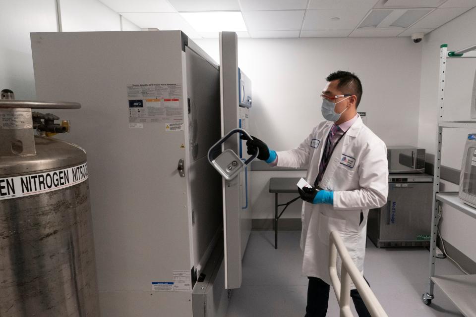 Pharmacist Billy Sin shows the refrigerator for doses of COVID-19 vaccines on Dec. 9, 2020 at Mount Sinai Queens hospital in New York.
