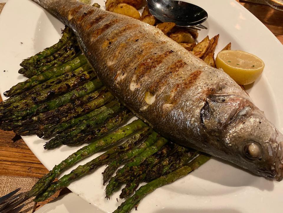 plate of a full sea bass from wine bar george at disney springs