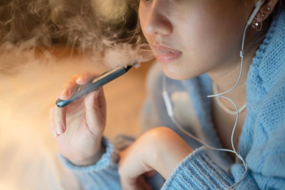 A woman vaping. 