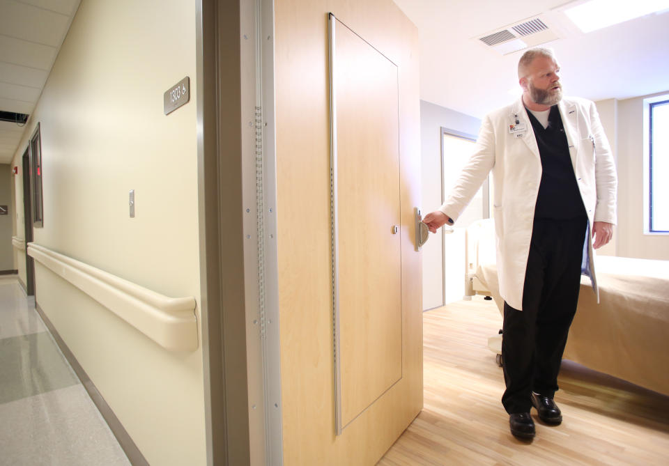 Dr. Brian Hyatt describes the additional access safety door in one of the medical psychiatric rooms at Northwest Medical Center-Springdale in 2018. (Arkansas Democrat-Gazette)