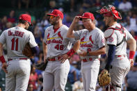 St. Louis Cardinals manager Mike Shildt, second from right, talks with shortstop Paul DeJong, left, first baseman Paul Goldschmidt, second from left, and catcher Andrew Knizner, right, as they wait for relief pitcher Andrew Miller during the sixth inning of a baseball game against the Chicago Cubs in Chicago, Sunday, Sept. 26, 2021. (AP Photo/Nam Y. Huh)