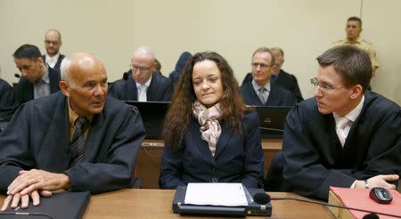 Defendant Beate Zschaepe sits with her lawyers Hermann Borchert (L) and Mathias Grasel (2nd R) prior to the continuation of her trial at a courtroom in Munich, southern Germany, December 9, 2015. REUTERS/Michael Dalder