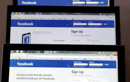 Computer screens display the Facebook sign-in screen in this photo illustration taken in Golden, Colorado July 28, 2015. REUTERS/Rick Wilking