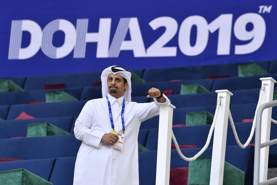 An official waits for the start of competitions at the World Athletics Championships Friday, Sept. 27, 2019, in Doha, Qatar. (AP Photo/Martin Meissner)