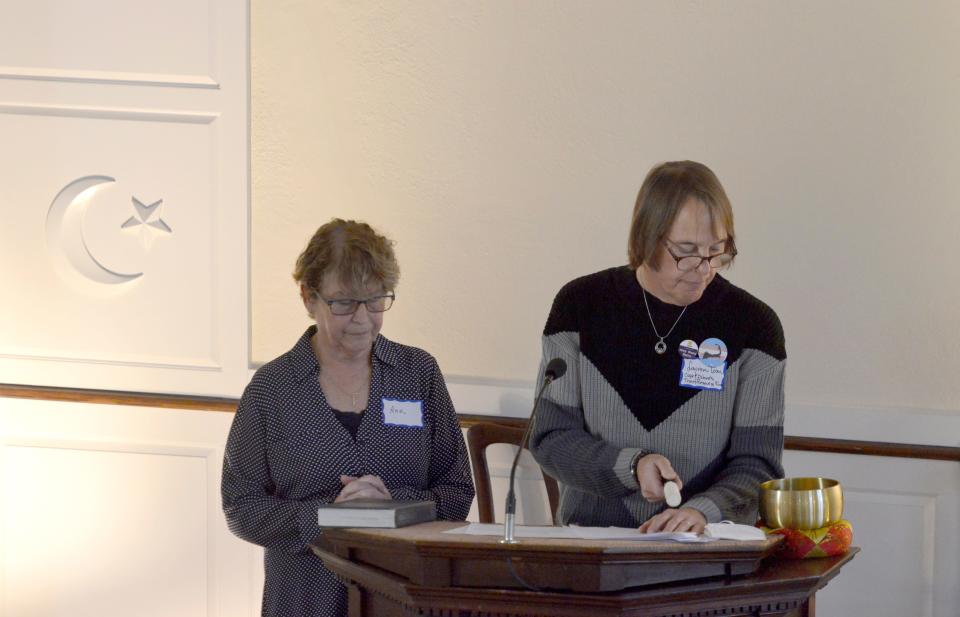 With Ann Burke, Lauren Tom, co-chair of the Cape and Islands Trans Resource Fund, right, rings a bell at a vigil on Sunday, saying the name for each of the five victims of the Club Q shooting. Burke is the Cape Cod advocate for Fenway Health's Violence Recovery Program and founder and co-chair of the Cape and Islands Trans Resource Fund.