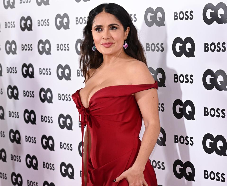 A close-up of Salma in a low-cut, off-the-shoulder dress