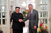 <p>North Korea’s leader Kim Jong Un shakes hands with Singapore’s Prime Minister Lee Hsien Loong at the Istana in Singapore, June 10, 2018 in this picture obtained from social media. (Photo: Singpore’s Ministry of Communications and Information via Reuters) </p>