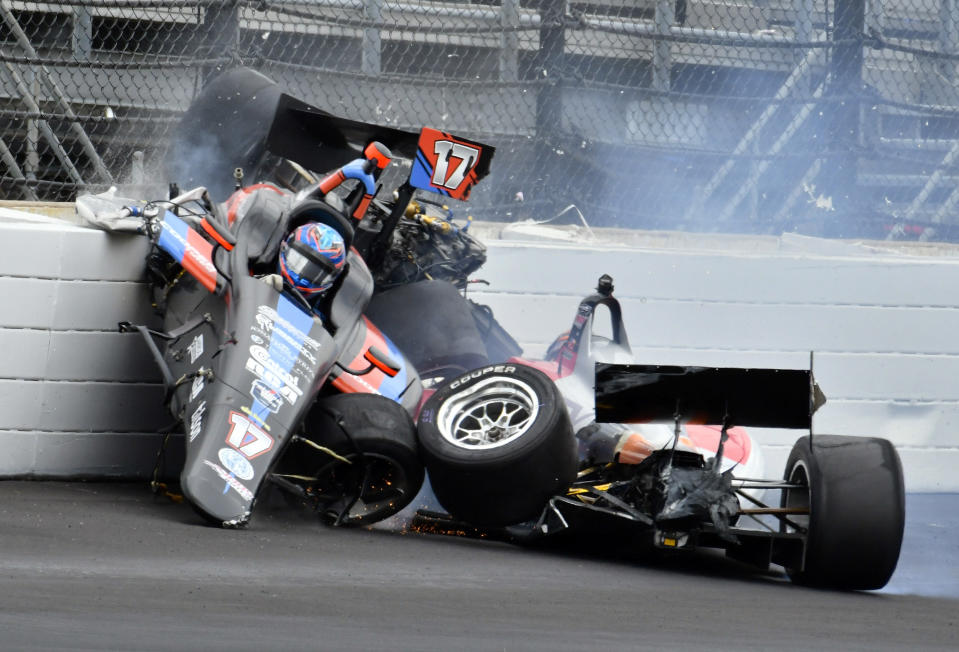 The car driven by Chris Windom (17) rides on the top of the car driven by David Malukas after a crash in the fourth turn during the running of the Indy Lights Freedom 100 IndyCar auto race at Indianapolis Motor Speedway, Friday, May 24, 2019, in Indianapolis. (AP Photo/Larry Drake)
