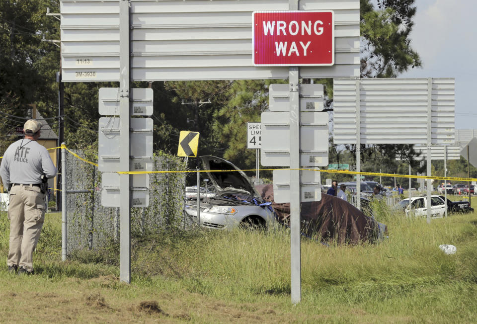 A Mandeville police car is covered with a tarp, after two Mandeville police officers were shot after a vehicle chase, one fatally, near the U.S. 190 and Louisiana Highway 22 exit in Mandeville, La., Friday, Sept. 20, 2019. The suspects are in custody. (David Grunfeld/The Advocate via AP)