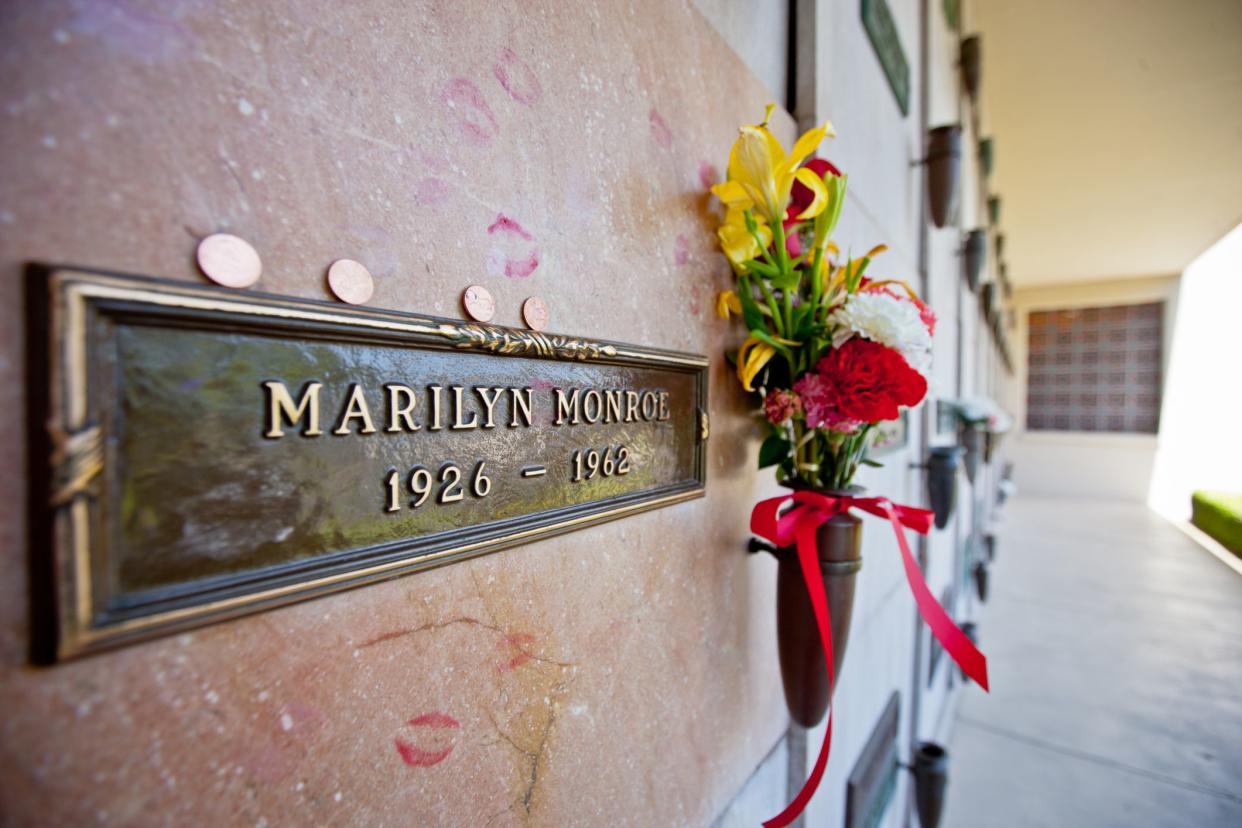 Los Angeles, USA  - May 15, 2013: Marilyn Monroe Grave with flowers and traces of kisses made by her fans, Westwood Village Memorial Park,  Los Angeles