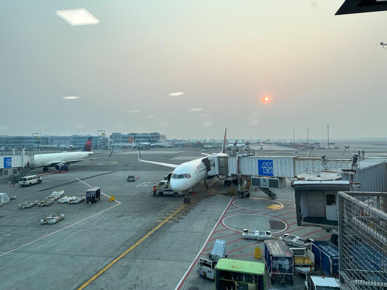 Smoke and haze hangs over the tarmac at JFK.