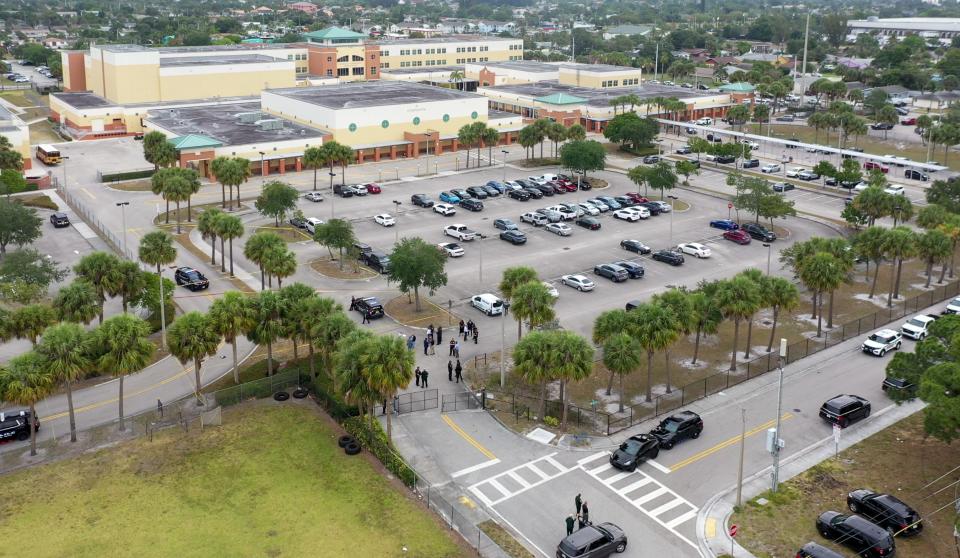 Police investigate the scene in the parking lot of Suncoast Community High School on April 22, 2024 in Riviera Beach, Florida.