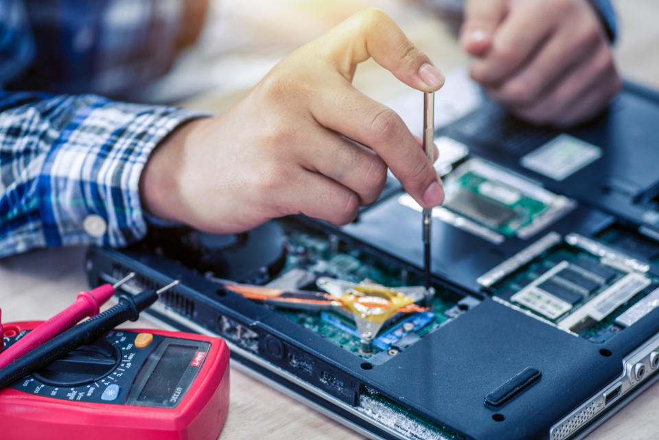 A person repairing a computer