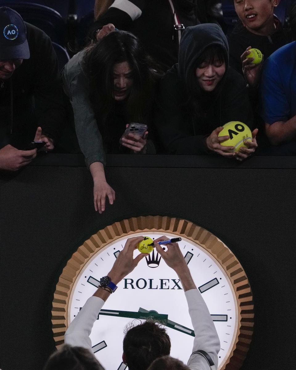 Daniil Medvedev of Russia signs autographs after defeating Emil Ruusuvuori of Finland in their second round match at the Australian Open tennis championships at Melbourne Park, Melbourne, Australia, Friday, Jan. 19, 2024. (AP Photo/Andy Wong)