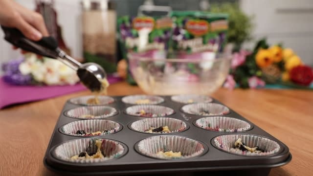 pouring muffin batter into cupcake tin