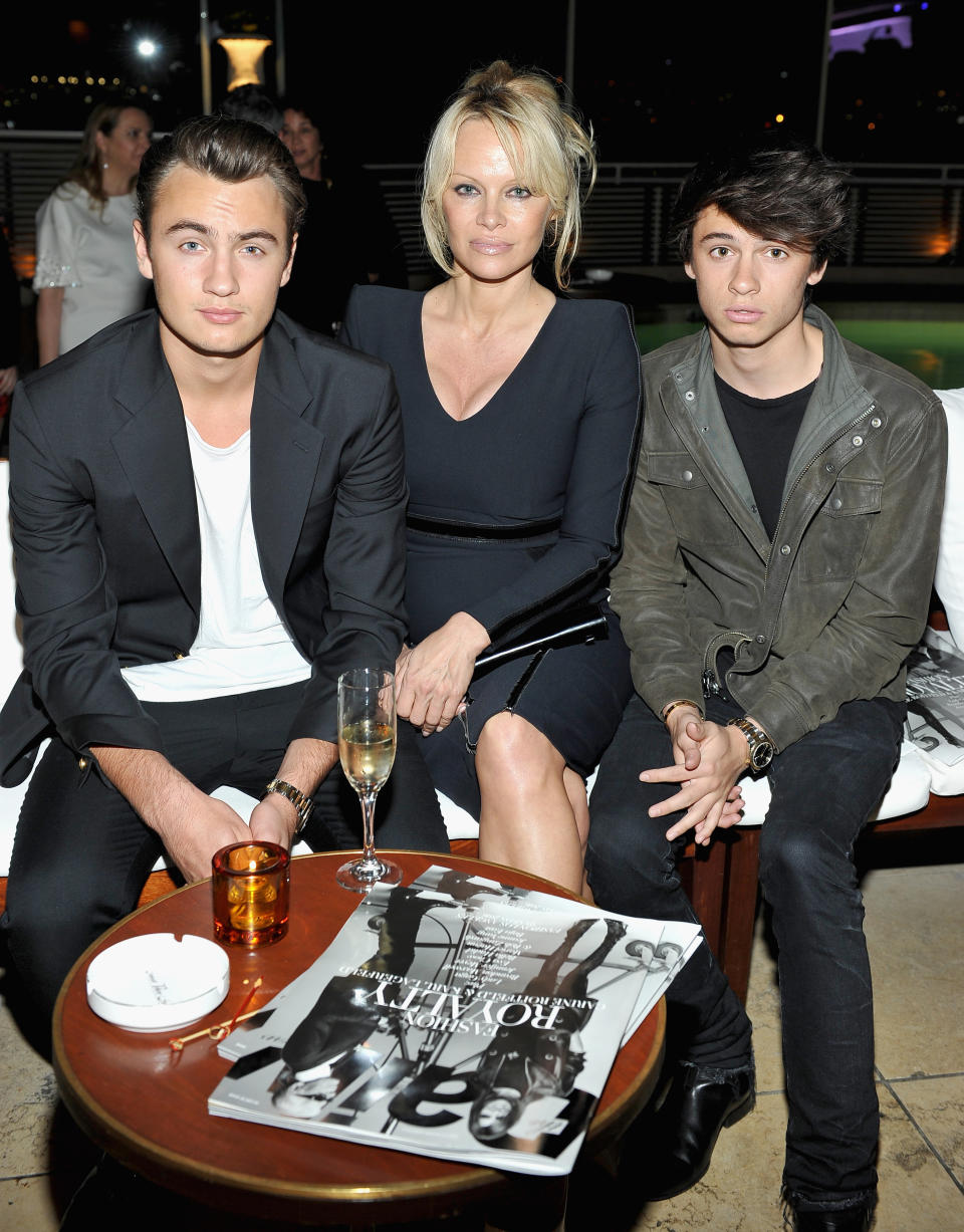 Pamela Anderson sits with her sons, Brandon and Dylan, at The Daily Front Row "Fashion Los Angeles Awards" in 2016