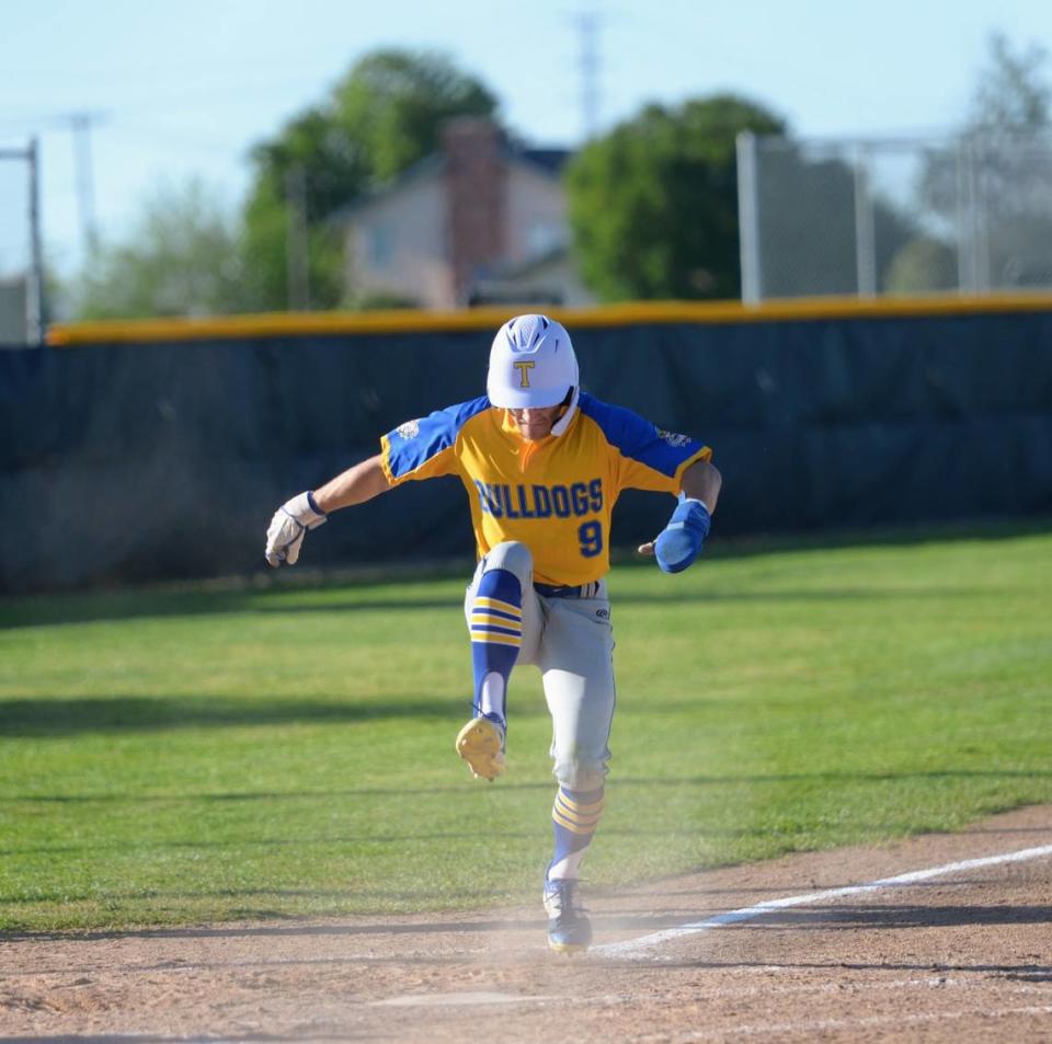 Turlock’s Carter Crivelli stomps on home plate to score the first run of the game in the top of the eighth inning during a CCAL matchup with Enochs at Enochs High School in Modesto, Calif. on Friday, April 19, 2024.
